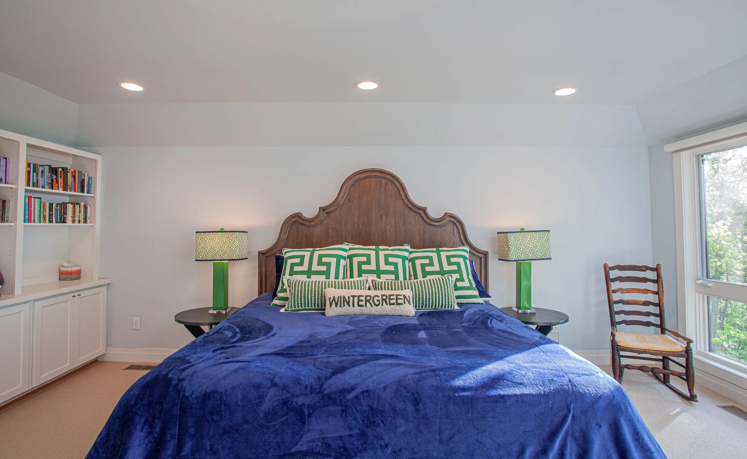 King bedroom with built-in bookshelves